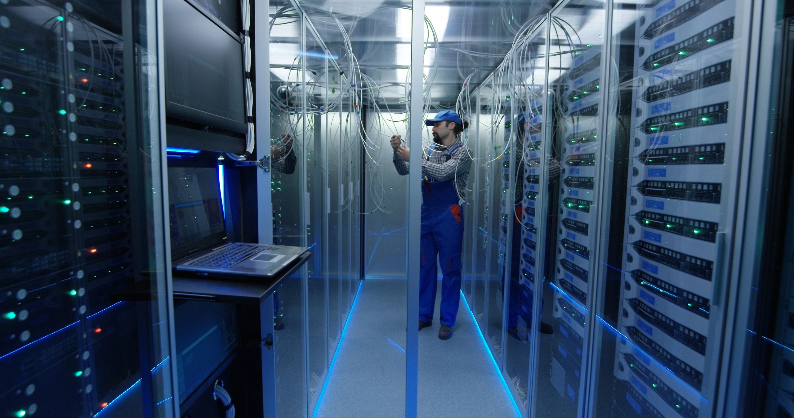 Engineer monitoring technical systems in a high-tech facility