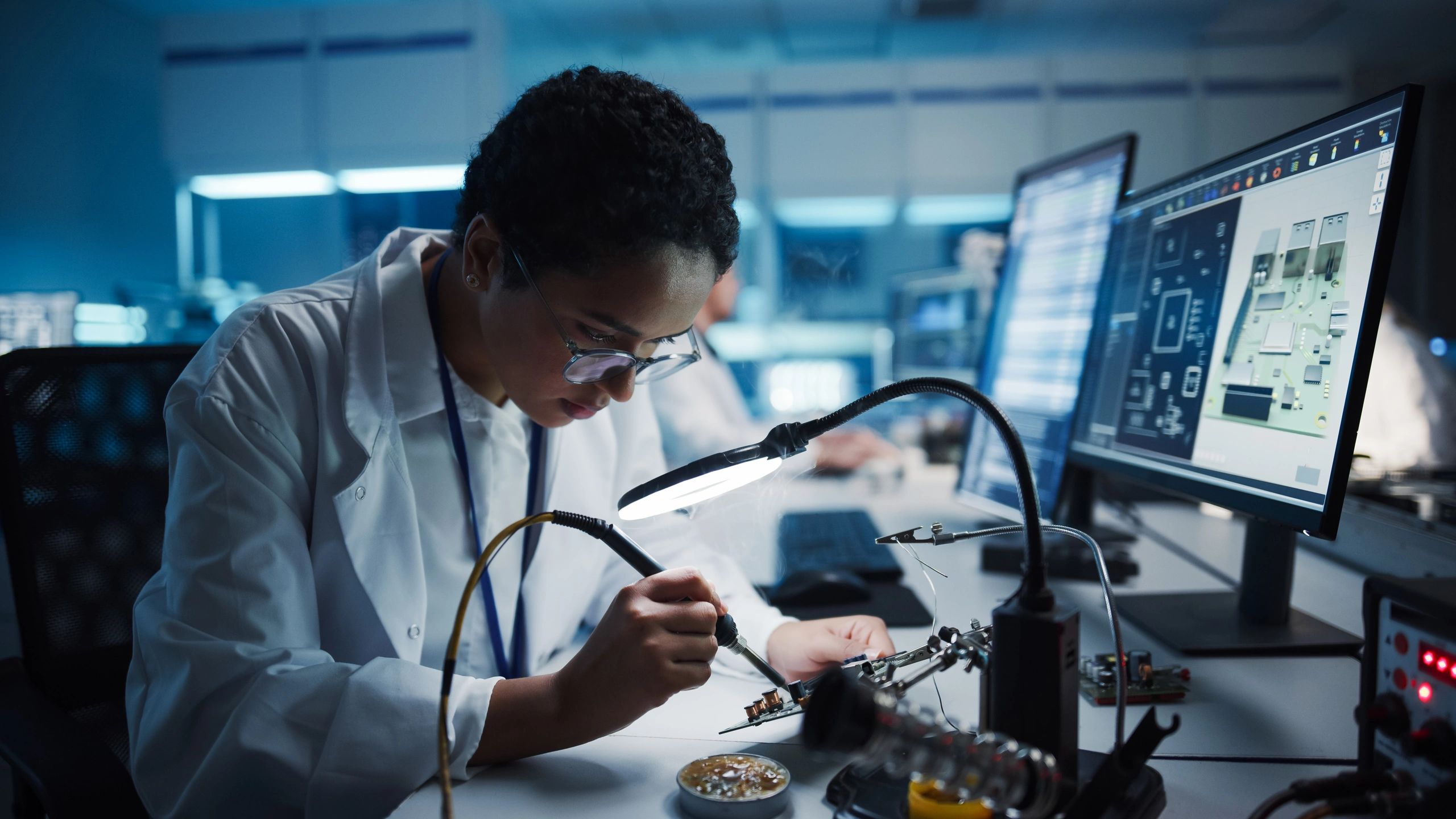 Engineer performing precision electronics work