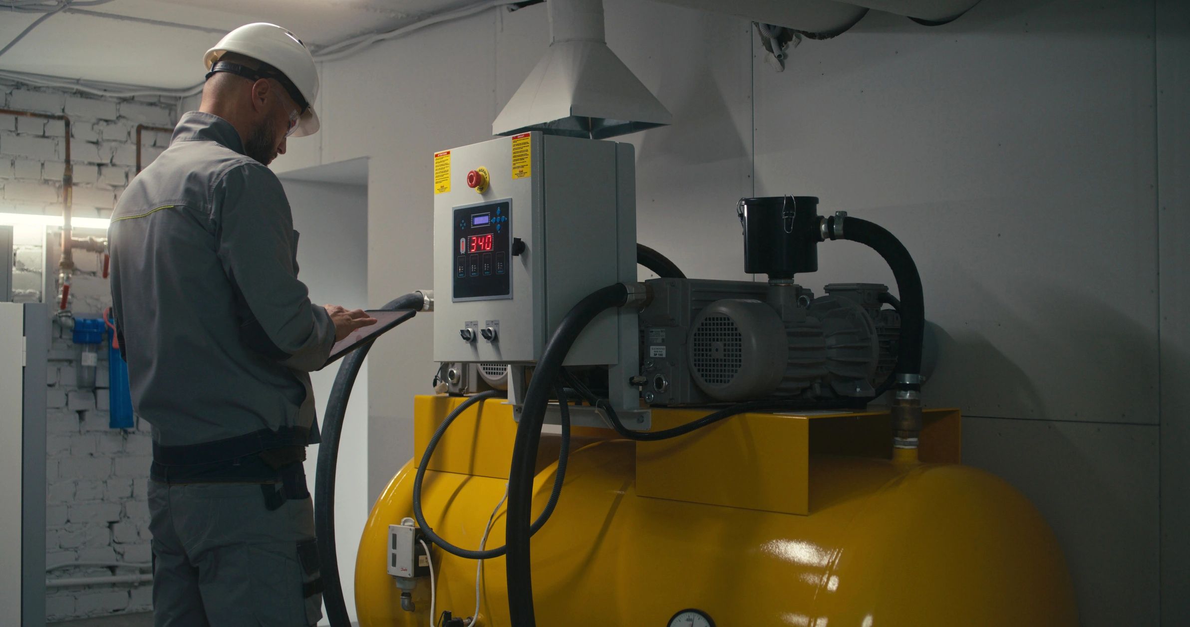 Engineer performing industrial vacuum system maintenance
