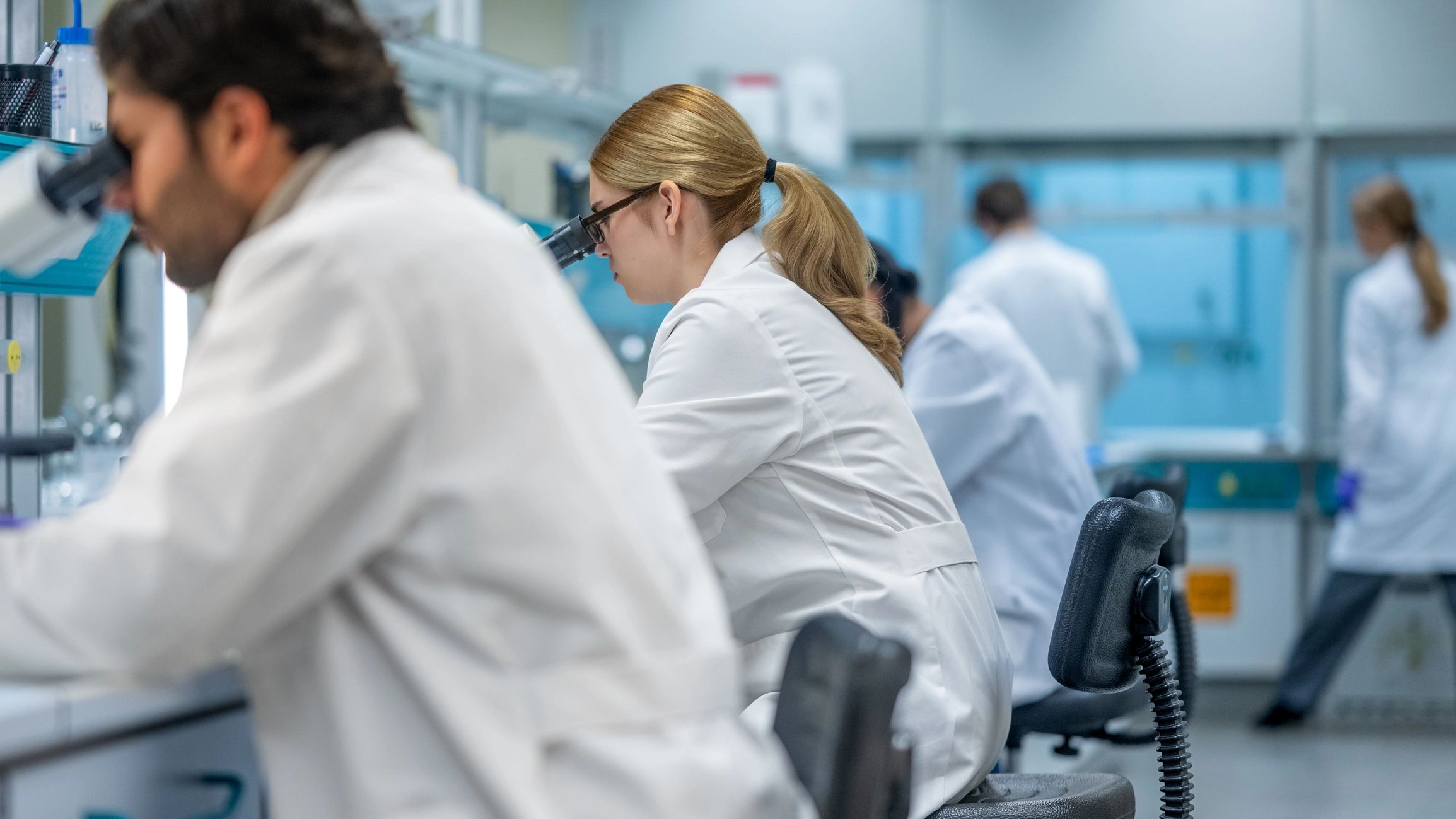 Engineering professionals working in a high-tech cleanroom environment