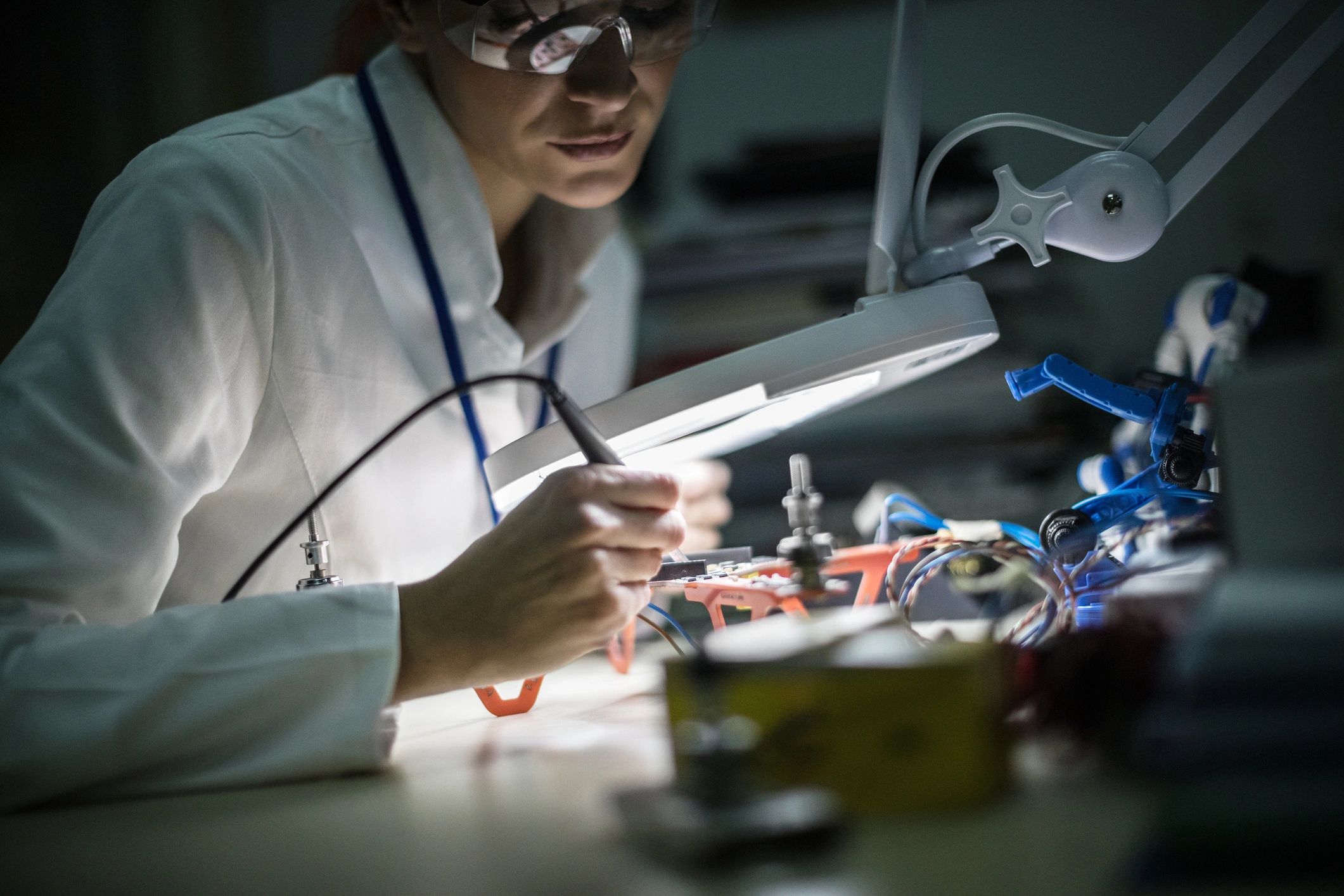 Technician working on detailed electronics repair